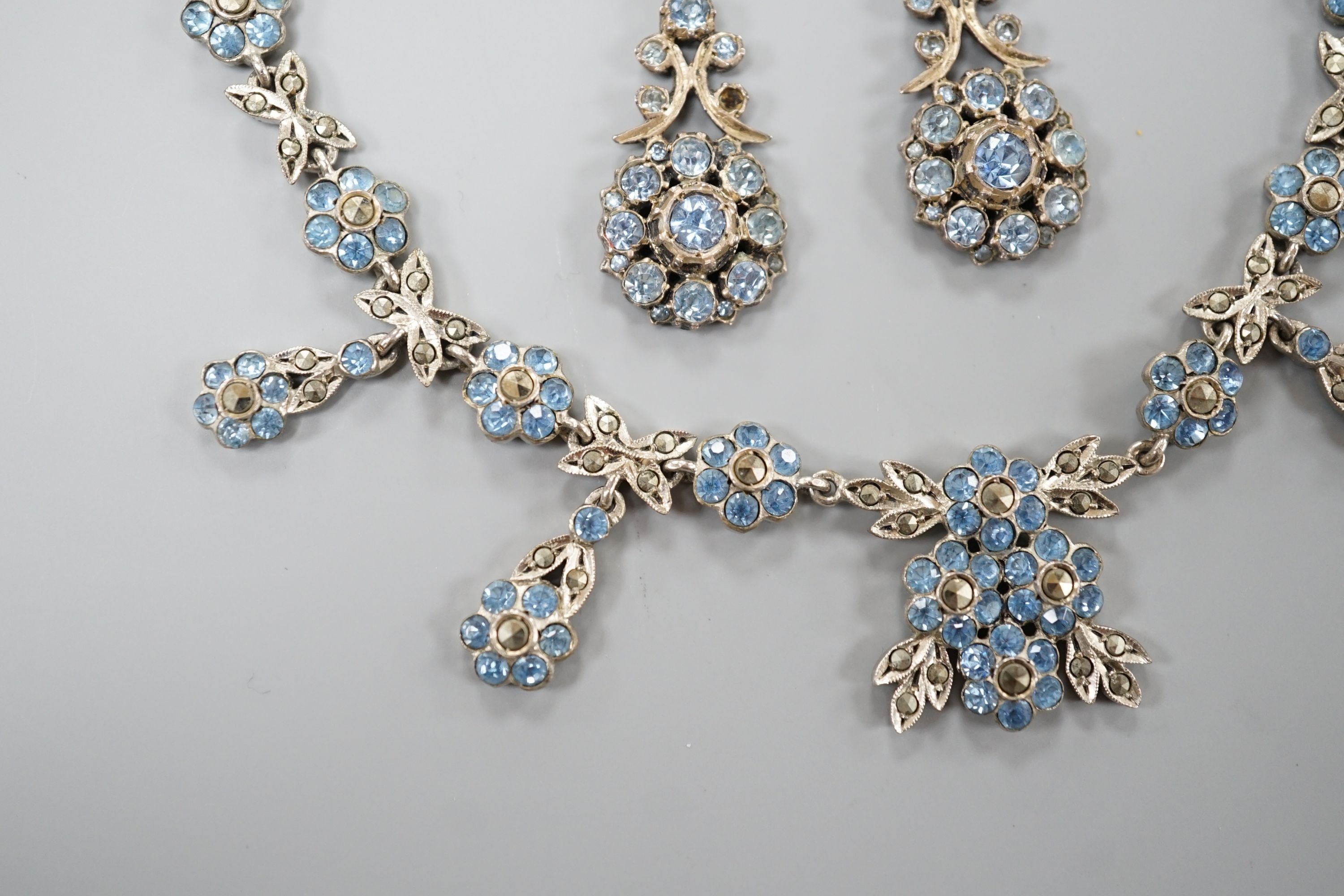 A base metal, marcasite and blue paste set necklace and pair of matching drop earrings, necklace 41cm, earrings 42mm.